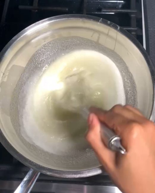 mixing egg white and sugar over double boiler