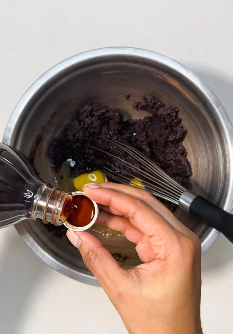 vanilla extract added to mixed sugar, cocoa powder and butter