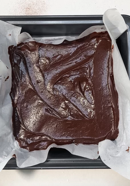brownie batter spread into 9x9 baking pan