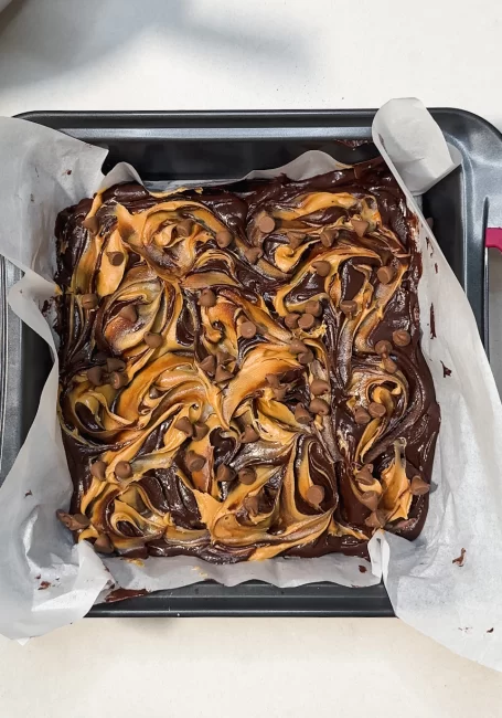 peanut butter swirled on peanut butter cup brownies batter