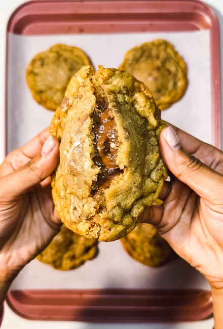 Nutella Stuffed Chocolate Chip Cookies (with Brown Butter) being ripped in half 