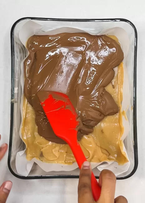 melted chocolate being spread over warm Chocolate Bar Fudge