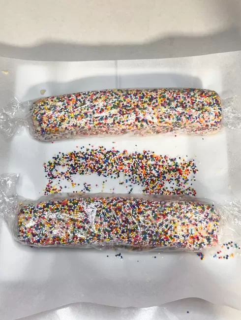 Vanilla Shortbread Cookie batter with sprinkles wrapped in plastic for refridgeration
