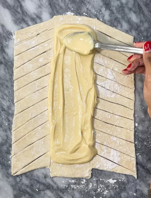 cream cheese filling spread onto prepared puff pastry