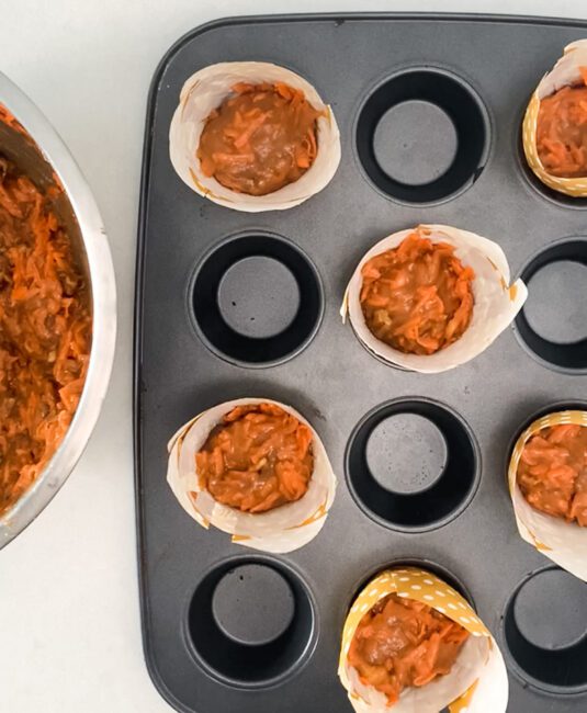 Carrot Cake Muffins with cream Cheese filling batter in muffin tin
