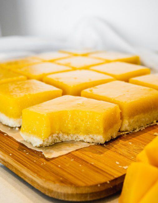 Mango Lemon Squares cut into squares on a cutting board
