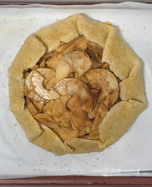 caramel apple galette before being baked with egg wash and sugar on top