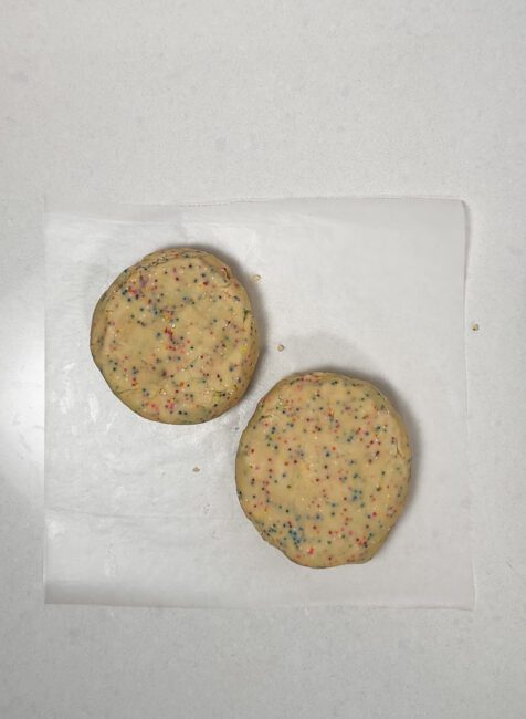 Two birthday cake sugar cookie dough disks 