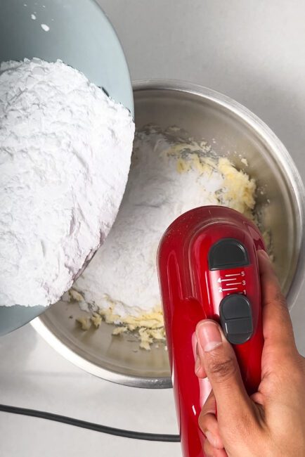 adding icing sugar to butter